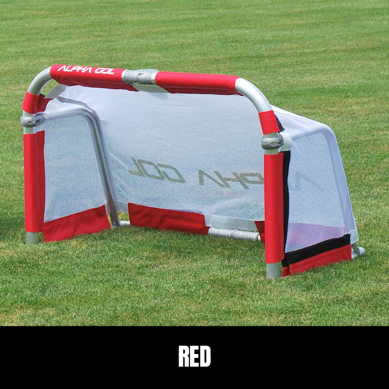 Red folding soccer goal on grass, front view, silver aluminum frame with white mesh netting