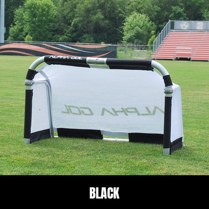Black folding soccer goal on grass, front view, silver aluminum frame with white mesh netting