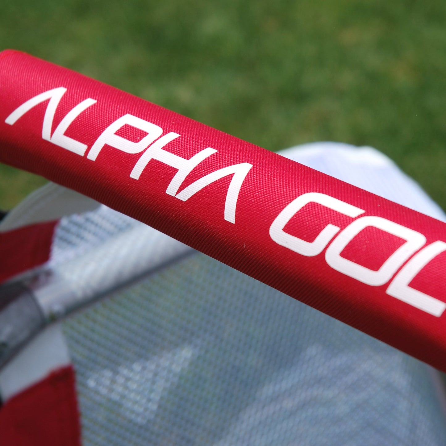 Alpha Gol branding printed in white on the red crossbar padding