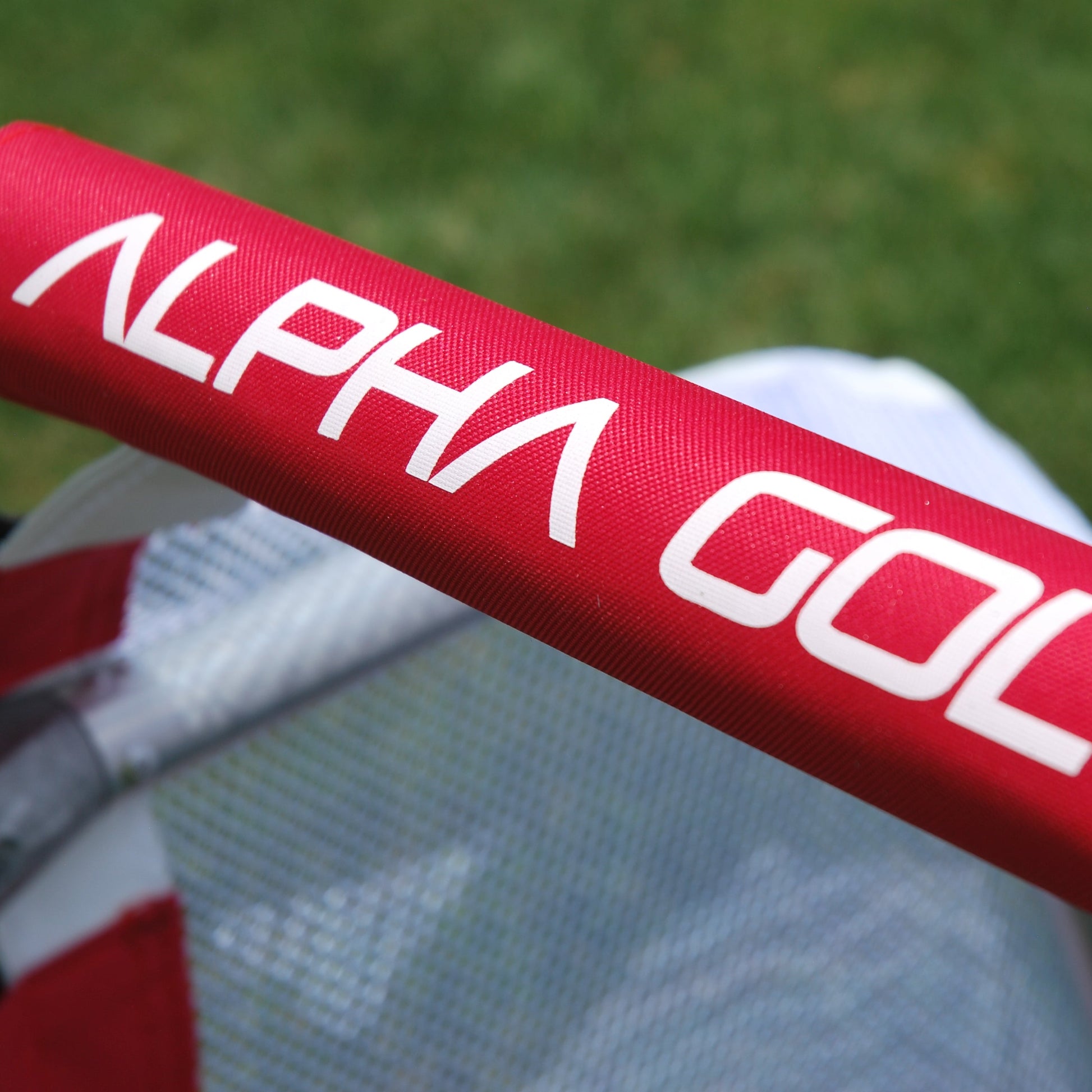 Alpha Gol branding printed in white on the red crossbar padding