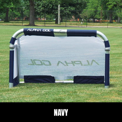 Navy folding soccer goal on grass, front view, silver aluminum frame with white mesh netting