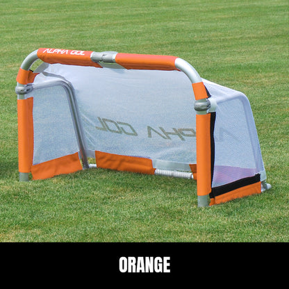 Orange folding soccer goal on grass, front view, silver aluminum frame with white mesh netting