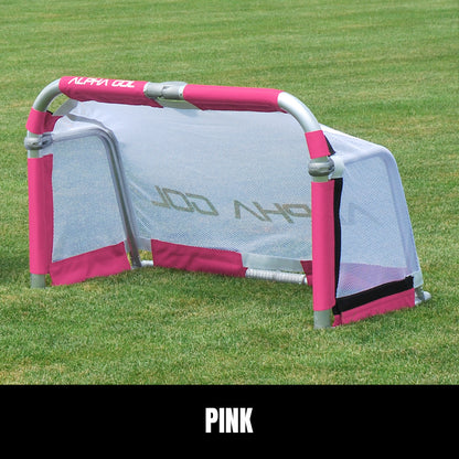 Pink folding soccer goal on grass, front view, silver aluminum frame with white mesh netting