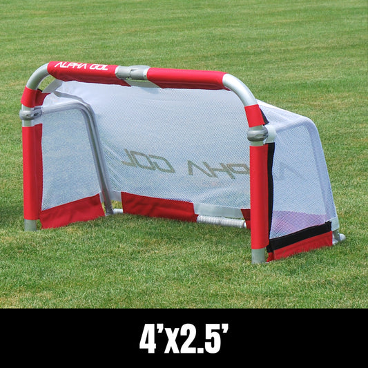Portable soccer goal on a green grass field, red and silver frame with white mesh netting